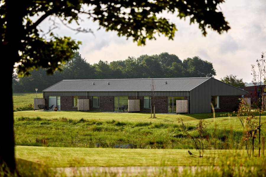 Past and future meet in steel-clad terraced houses with history in the backyard, Jernaldervej 8, 8600 Silkeborg, Denmark